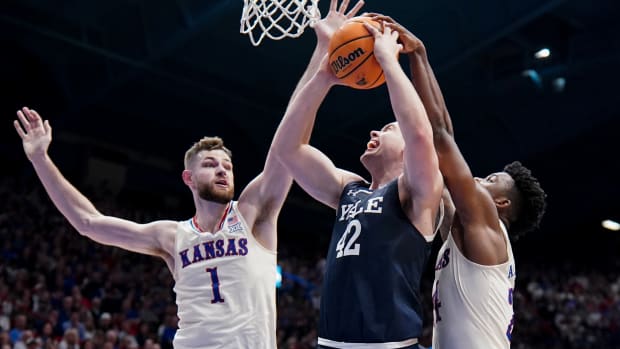 Dec 22, 2023; Lawrence, Kansas, USA; Kansas Jayhawks forward K.J. Adams Jr. (24) blocks the shot of Yale Bulldogs forward Nick Townsend (42) during the first half at Allen Fieldhouse.